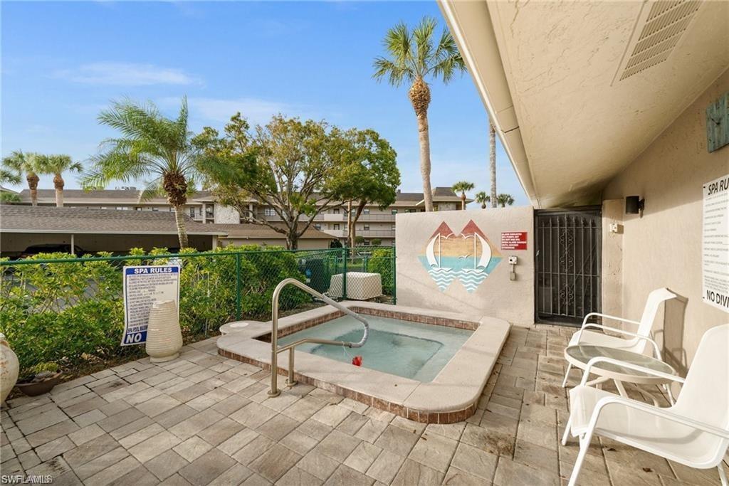 1790 Imperial Golf Course Boulevard, Unit A205 Naples, FL 34110 - Photo 27 of 28 a view of a chairs and table in patio