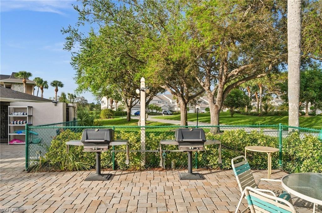 1790 Imperial Golf Course Boulevard, Unit A205 Naples, FL 34110 - Photo 28 of 28 a view of yard with seating area and trees
