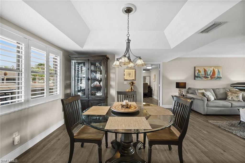 1790 Imperial Golf Course Boulevard, Unit A205 Naples, FL 34110 - Photo 3 of 28 a view of a dining room with furniture window and wooden floor