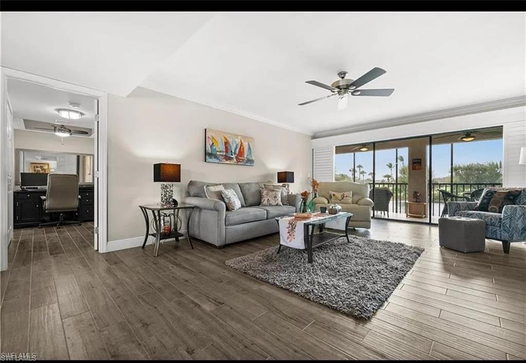 1790 Imperial Golf Course Boulevard, Unit A205 Naples, FL 34110 - Photo 4 of 28 a living room with furniture and a wooden floor