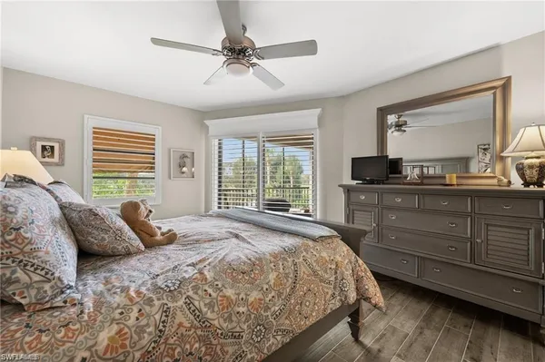 a bedroom with a large bed and a large window