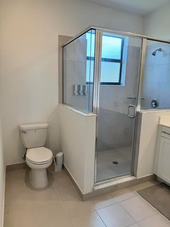 a bathroom with a toilet and a shower