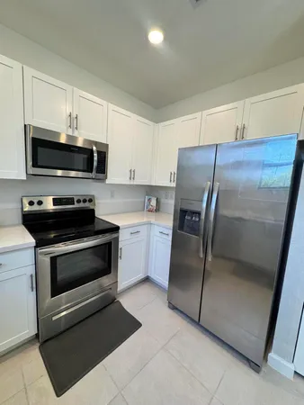 a kitchen with a refrigerator stove and microwave