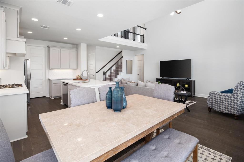 9600 Acorn Lane Little Elm, TX 75068 - Photo 12 of 34 a living room with stainless steel appliances furniture a rug and a flat screen tv