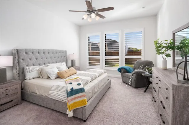 a spacious bedroom with a bed and a couch