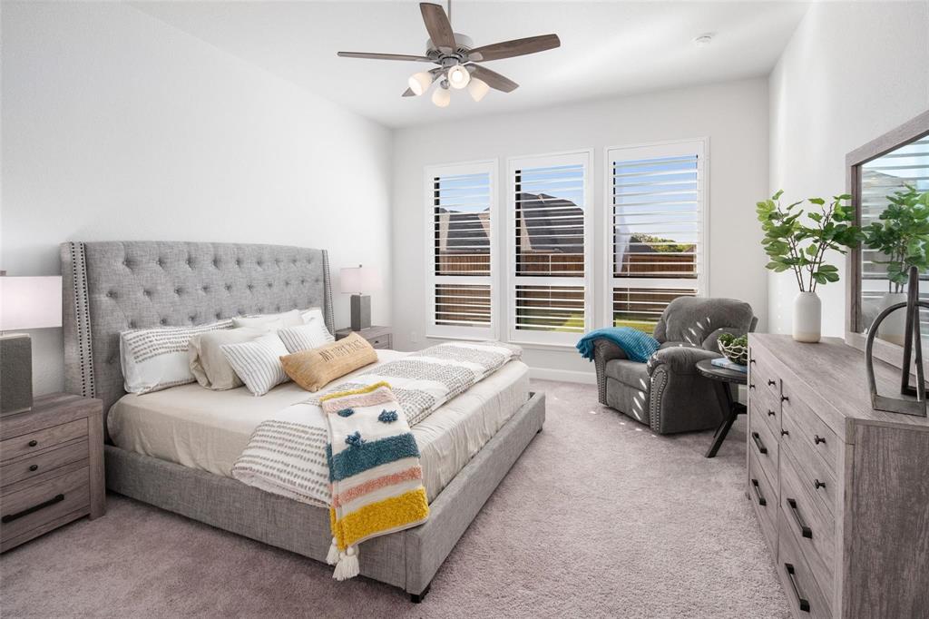 9600 Acorn Lane Little Elm, TX 75068 - Photo 13 of 34 a spacious bedroom with a bed and a couch