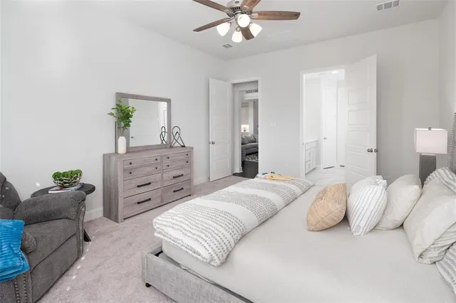 a bedroom with a bed and ceiling fan