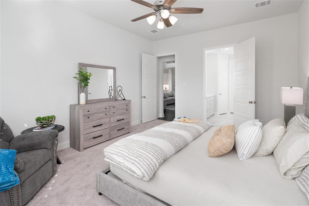 9600 Acorn Lane Little Elm, TX 75068 - Photo 14 of 34 a bedroom with a bed and ceiling fan