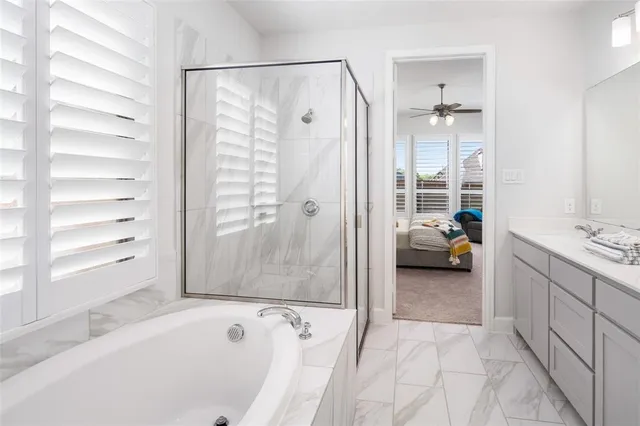 a bathroom with a tub shower and sink