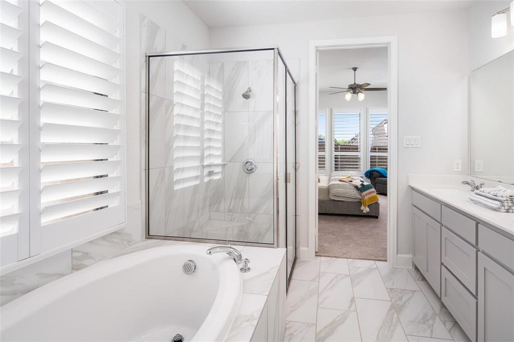 9600 Acorn Lane Little Elm, TX 75068 - Photo 16 of 34 a bathroom with a tub shower and sink