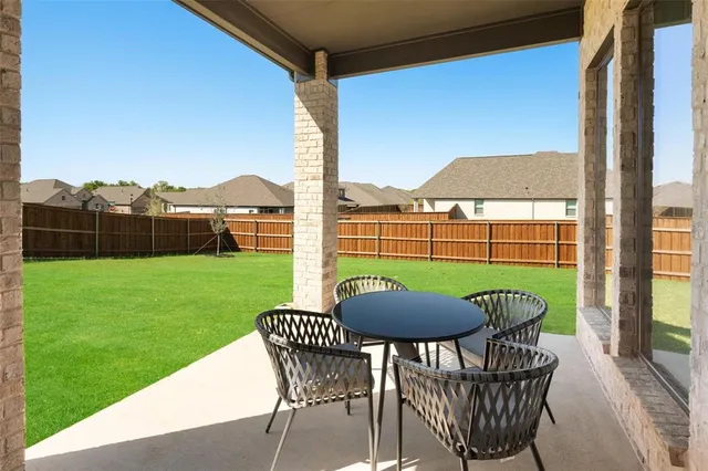 a view of a chair and table on the deck