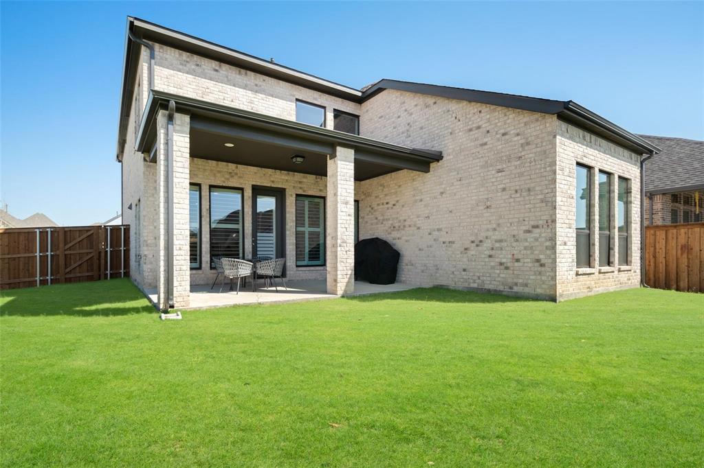 9600 Acorn Lane Little Elm, TX 75068 - Photo 26 of 34 a view of a house with backyard and porch