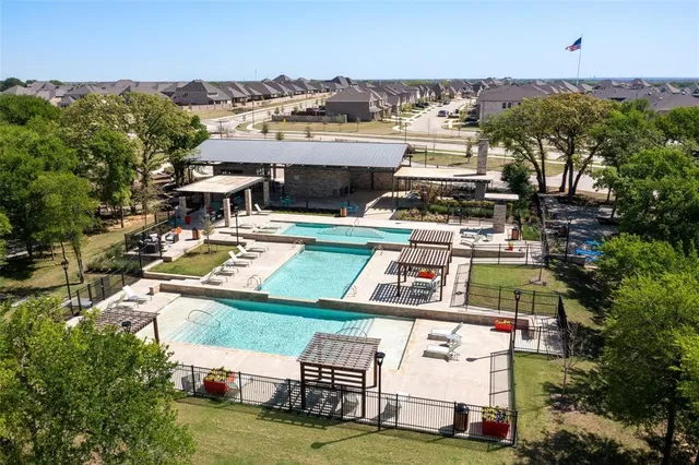 an aerial view of a house with a yard swimming pool and outdoor seating