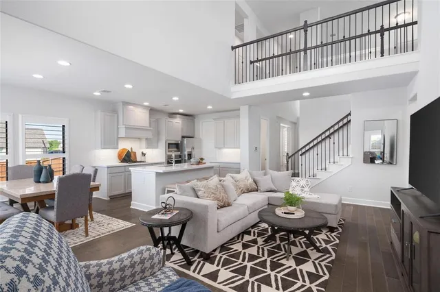 a living room with furniture kitchen view and a dining table