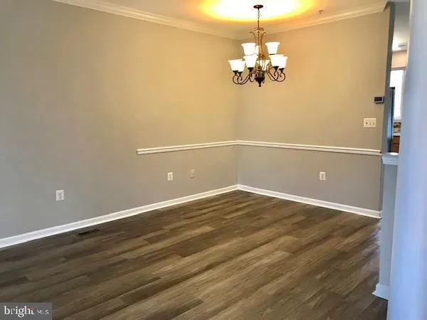 a view of a room with wooden floor and chandelier