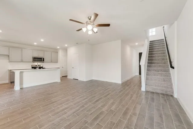 a view of kitchen with granite countertop cabinets and refrigerator