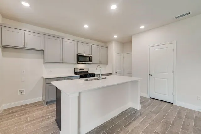 a kitchen with wooden cabinets and white appliances