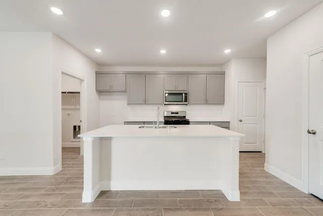 a view of a kitchen with stainless steel appliances cabinets
