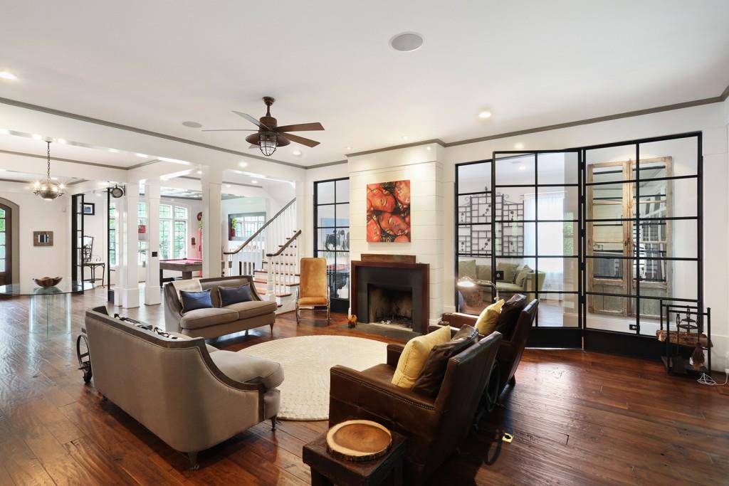 1692 Friar Tuck Road Northeast Atlanta, GA 30309 - Photo 10 of 41 a living room with furniture a fireplace and a floor to ceiling window