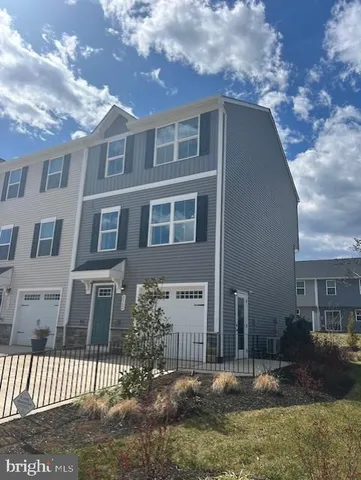 a view of a brick house next to a yard