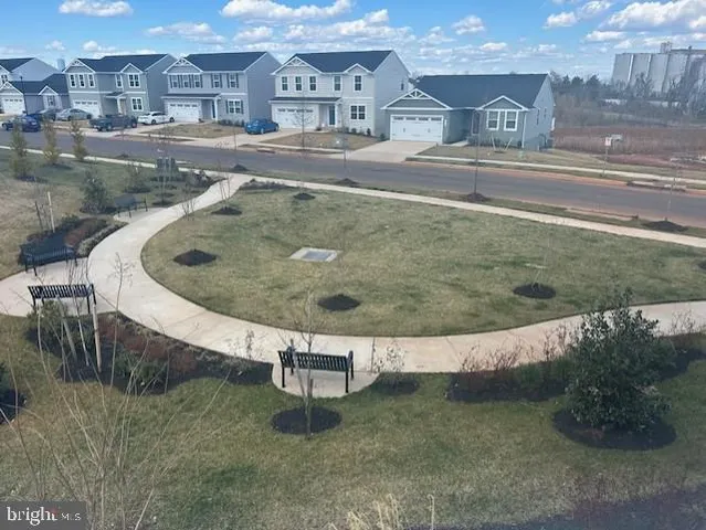a view of a water fountain in front of a house