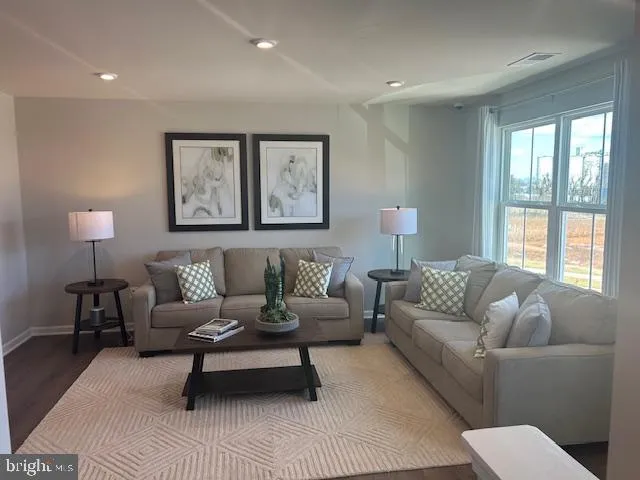 a living room with furniture and a lamp