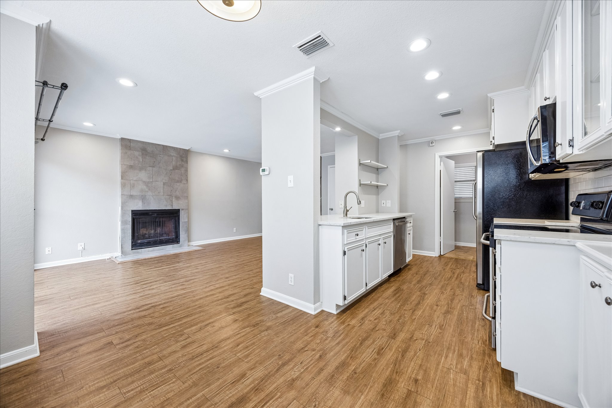 3845 Ranch Road 2222, Unit 33 Austin, TX 78731 - Photo 7 of 21 a kitchen with stainless steel appliances a refrigerator and a stove top oven