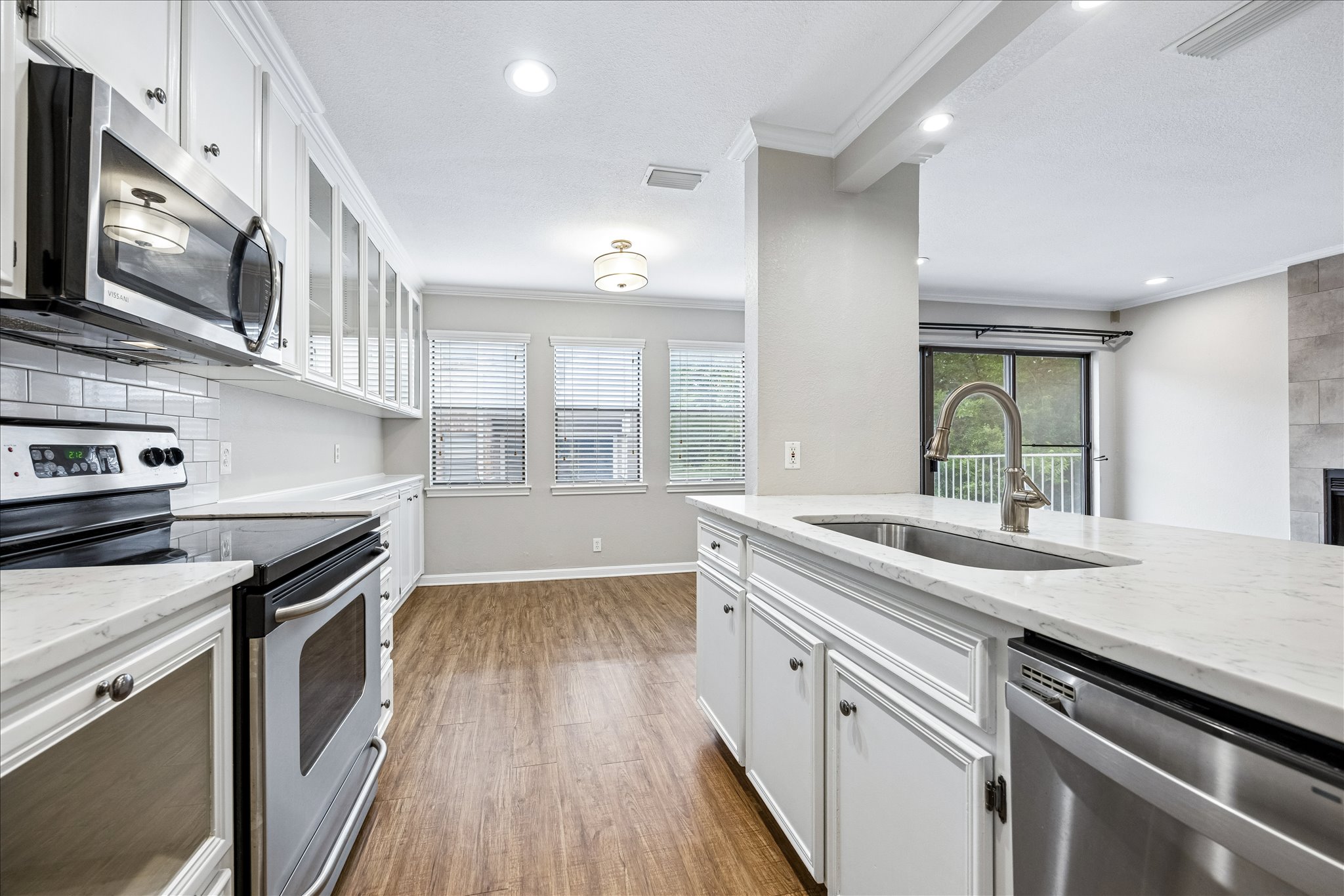 3845 Ranch Road 2222, Unit 33 Austin, TX 78731 - Photo 8 of 21 a kitchen with a sink stove and cabinets