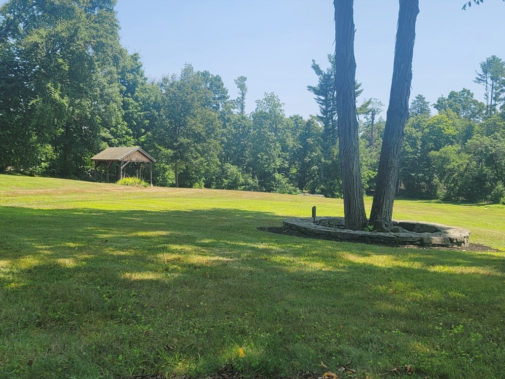 0 Old Dunstable Road Groton, MA 01450 - Photo 14 of 32 a view of a swimming pool with a yard and large trees