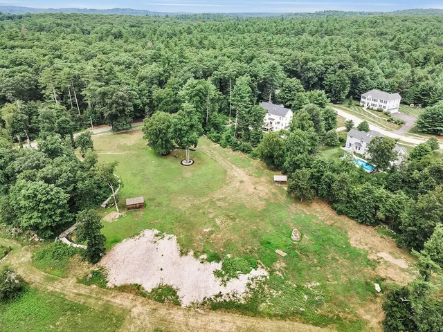 a backyard of a house with a yard and outdoor seating