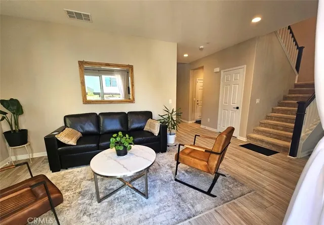 a bedroom with a bed and dresser with mirror