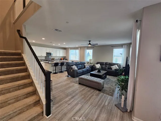 a room with pool table flat screen tv and windows