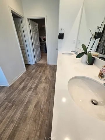 a view of staircase with lots of frames on wall and a window