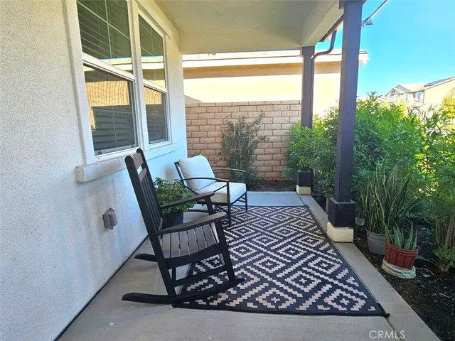 a living room with furniture a large window and kitchen view