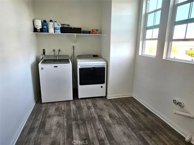 a bathroom with a sink a toilet a mirror and shower