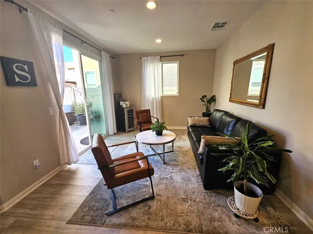 a living room with furniture and a potted plant