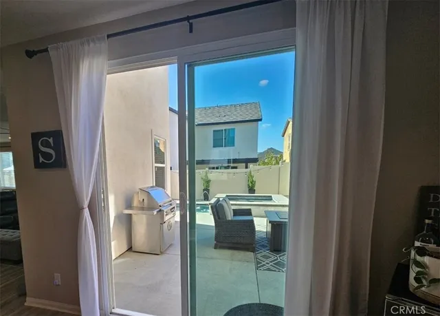 a kitchen with sink refrigerator dining table and chairs