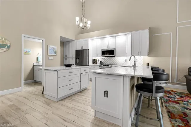 a kitchen with a refrigerator and a stove top oven