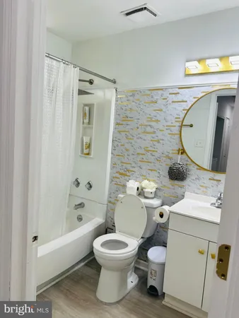 a bathroom with a toilet a sink and bathtub