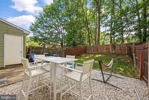 a view of a backyard with sitting area