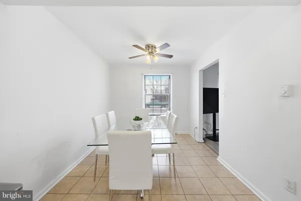 a living room with furniture a chandelier and a dining table