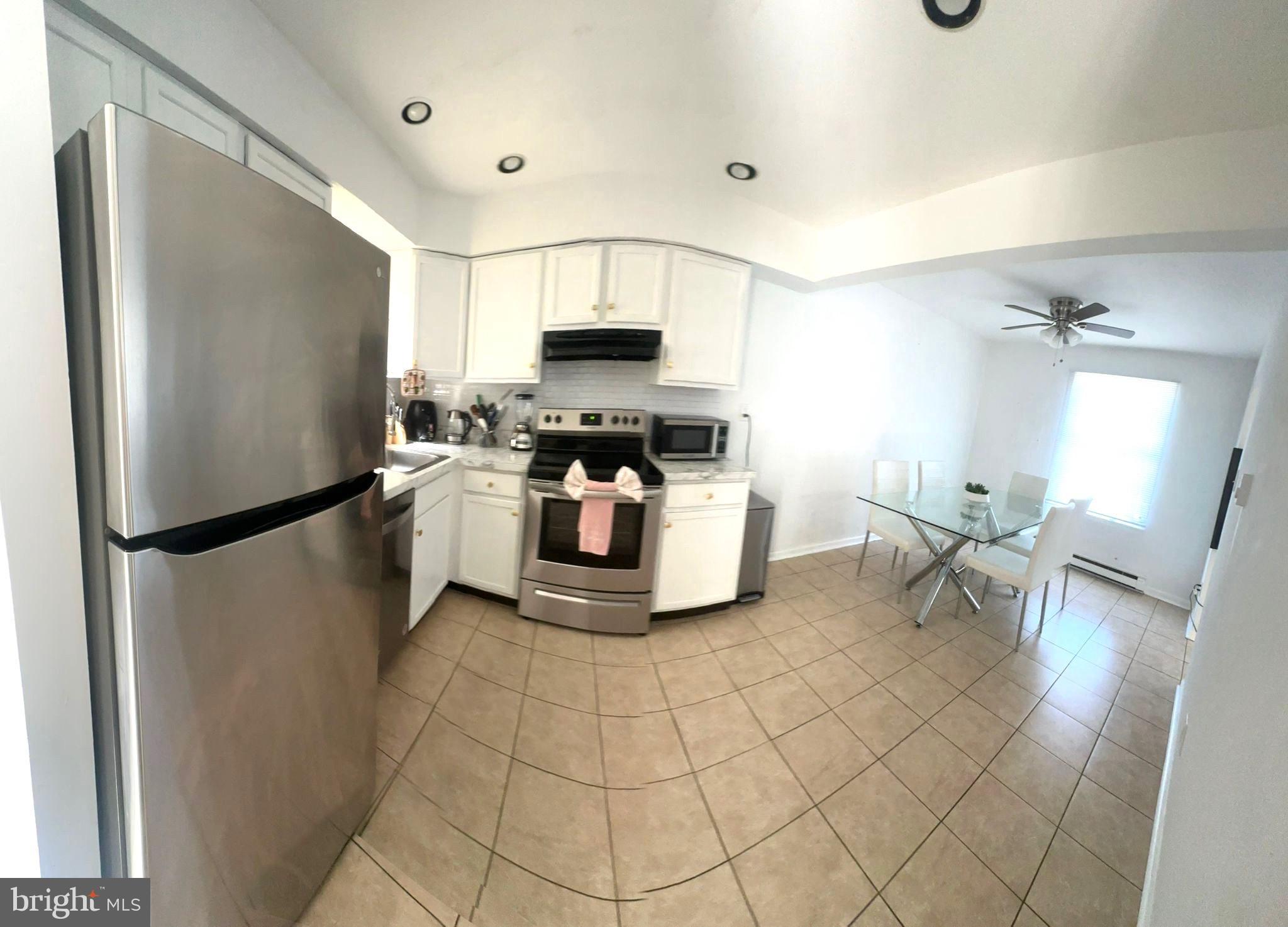 31 Brookshire Road Sicklerville, NJ 08081 - Photo 6 of 12 a kitchen with stainless steel appliances a refrigerator sink and stove
