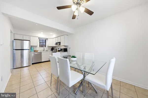 a kitchen with stainless steel appliances kitchen island granite countertop a refrigerator and microwave