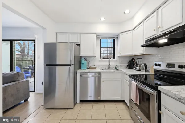 a kitchen with a refrigerator sink and stove top oven