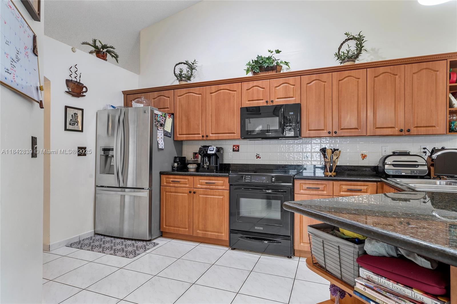 1841 Southwest 124th Way Miramar, FL 33027 - Photo 11 of 34 a kitchen with stainless steel appliances granite countertop a refrigerator and a stove top oven