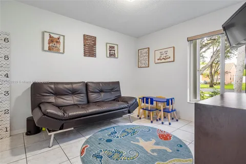 a living room with furniture and a book shelf
