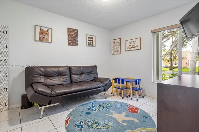a living room with furniture and a book shelf