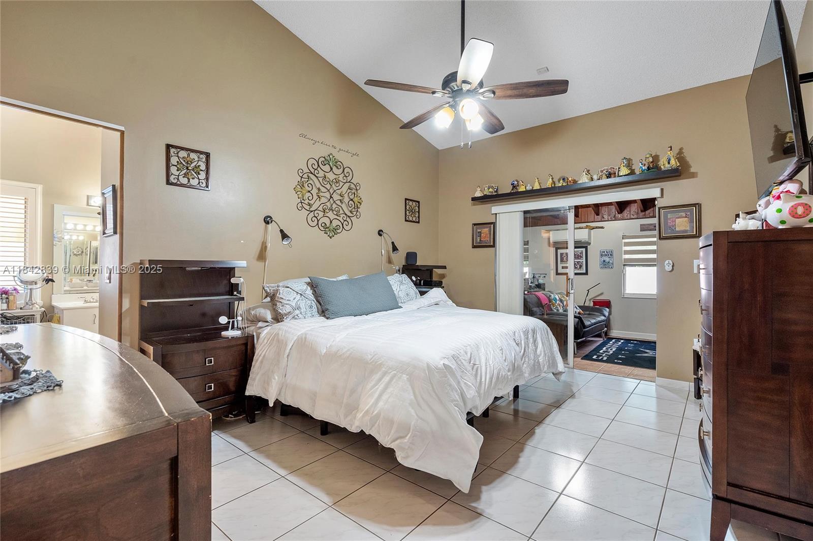 1841 Southwest 124th Way Miramar, FL 33027 - Photo 18 of 34 a bedroom with a bed and a chandelier