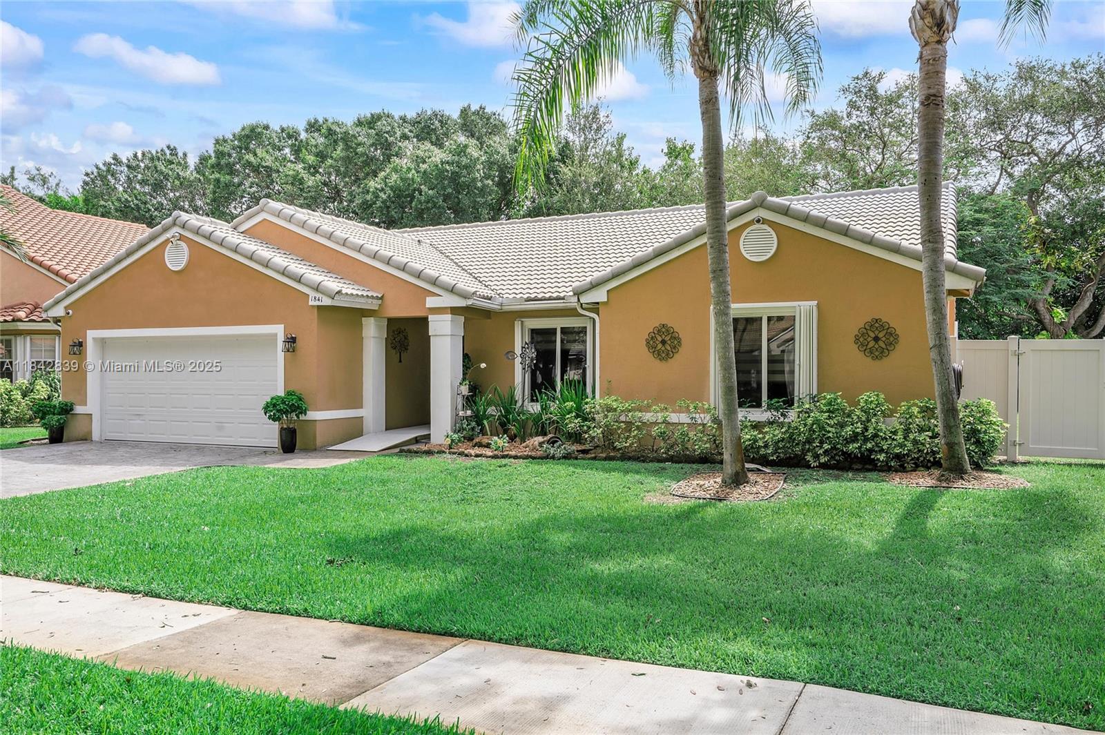 1841 Southwest 124th Way Miramar, FL 33027 - Photo 2 of 34 a view of a house with a yard and potted plants