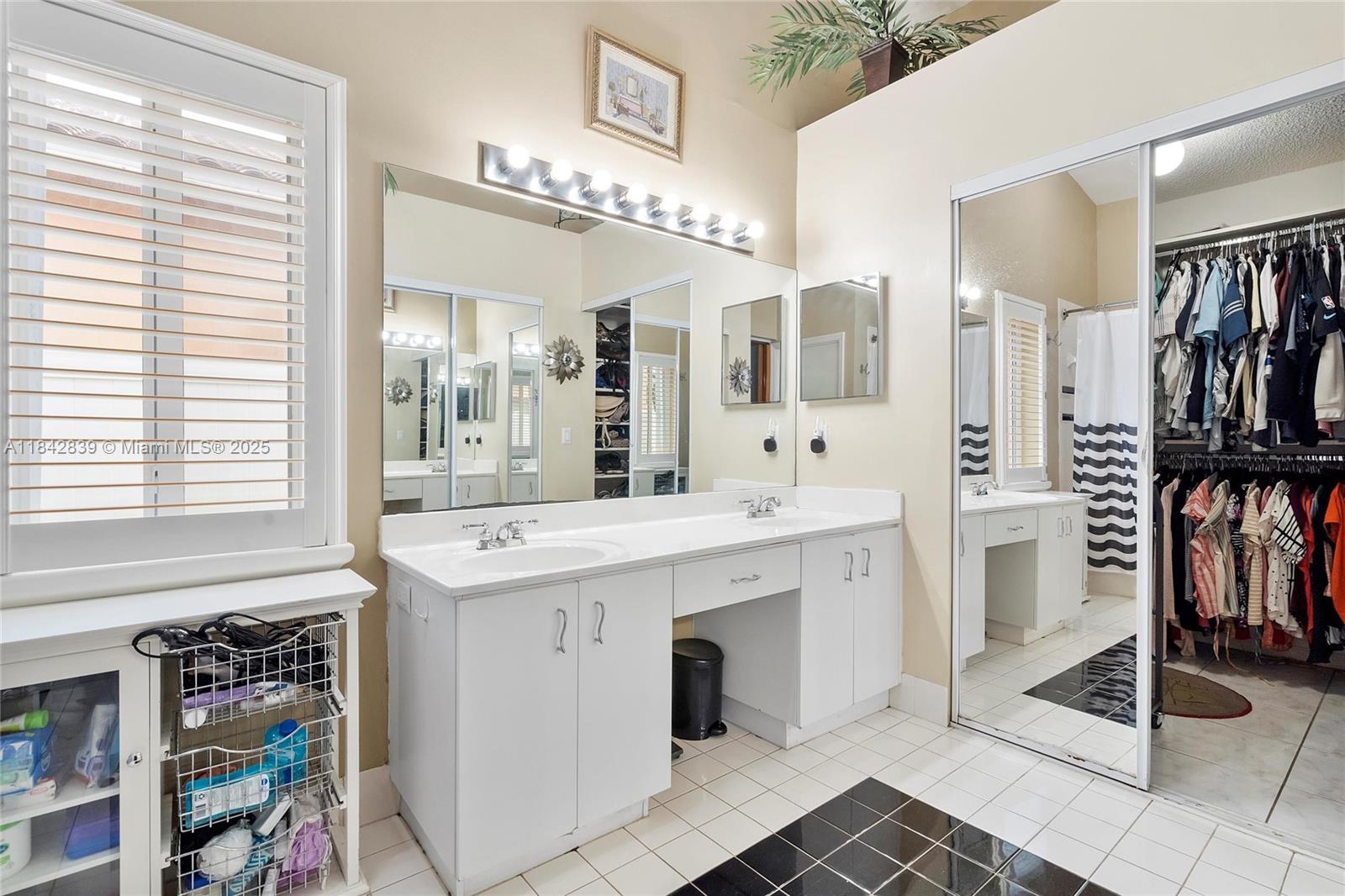 1841 Southwest 124th Way Miramar, FL 33027 - Photo 24 of 34 a spacious bathroom with a shower a sink and a large mirror